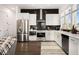 Bright kitchen boasting stainless appliances, white cabinetry, and black tile backsplash at 120 Beardon Se Cir # 2, Atlanta, GA 30316