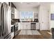 Bright kitchen featuring stainless steel appliances and white cabinetry with black tile backsplash at 120 Beardon Se Cir # 2, Atlanta, GA 30316