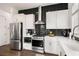 Charming kitchen with stainless steel appliances, white cabinetry, and modern black backsplash at 120 Beardon Se Cir # 2, Atlanta, GA 30316