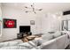 Bright living room with modern light fixture, entertainment center, and comfortable gray sofa at 120 Beardon Se Cir # 2, Atlanta, GA 30316