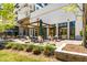 Beautifully landscaped patio with a pergola covering tables and chairs, surrounded by greenery and planters at 120 Beardon Se Cir # 2, Atlanta, GA 30316