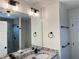 Bathroom featuring a modern mirror and vanity, with a tiled shower and black hardware at 121 Thirkield Se Ave, Atlanta, GA 30315