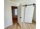 Bedroom featuring wood-look flooring and a barn door at 121 Thirkield Se Ave, Atlanta, GA 30315