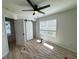 Bedroom featuring wood-look flooring, barn door, and a ceiling fan at 121 Thirkield Se Ave, Atlanta, GA 30315