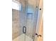 Modern bathroom shower featuring gray tile, glass doors and new shower head at 121 Thirkield Se Ave, Atlanta, GA 30315