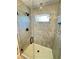 Modern shower featuring gray tile, glass door, showerhead, and a built-in niche for storage at 121 Thirkield Se Ave, Atlanta, GA 30315
