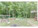 Spacious backyard featuring a fire pit, garden, and mature trees providing ample shade and privacy at 1258 Rocky Branch Trl, Lawrenceville, GA 30043