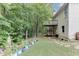 Exterior showing a home with a wooden deck, mature trees, and a large garden space at 1258 Rocky Branch Trl, Lawrenceville, GA 30043