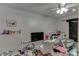 Untidy bedroom with white walls and wood-look floors featuring a crib, chair and sundry items at 1258 Rocky Branch Trl, Lawrenceville, GA 30043