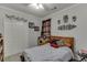 Comfortable bedroom with a bed and lots of decorative flourishes, including metal wall art at 1258 Rocky Branch Trl, Lawrenceville, GA 30043