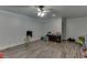 A spacious bedroom is brightly lit and has gray faux wood floors and is spacious at 1258 Rocky Branch Trl, Lawrenceville, GA 30043