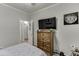 Bedroom featuring a chest of drawers with a TV and an interesting piece of wall art at 1258 Rocky Branch Trl, Lawrenceville, GA 30043
