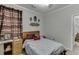 Comfortable bedroom with a bed and lots of decorative flourishes, including metal wall art at 1258 Rocky Branch Trl, Lawrenceville, GA 30043
