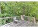 Outdoor wooden deck with comfortable seating and natural backdrop at 1258 Rocky Branch Trl, Lawrenceville, GA 30043