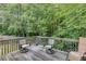 Cozy wooden deck with chairs, perfect for relaxing and enjoying the outdoor scenery at 1258 Rocky Branch Trl, Lawrenceville, GA 30043