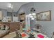 Dining area with unique light fixture adjacent to the kitchen and living spaces at 1258 Rocky Branch Trl, Lawrenceville, GA 30043