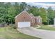 Charming single-Gathering home featuring a well-manicured lawn and traditional brick facade at 1258 Rocky Branch Trl, Lawrenceville, GA 30043