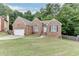 Charming single-Gathering home featuring a well-manicured lawn and traditional brick facade at 1258 Rocky Branch Trl, Lawrenceville, GA 30043