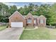 Charming single-Gathering home featuring a well-manicured lawn and traditional brick facade at 1258 Rocky Branch Trl, Lawrenceville, GA 30043