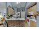 Efficient kitchen with wooden cabinets, brick backsplash, and a breakfast bar at 1258 Rocky Branch Trl, Lawrenceville, GA 30043