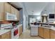 Practical kitchen with wood cabinetry, white appliances, and neutral countertops at 1258 Rocky Branch Trl, Lawrenceville, GA 30043