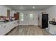 Simple kitchen features white cabinets, brick accent wall, and modern appliances at 1258 Rocky Branch Trl, Lawrenceville, GA 30043