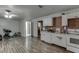Open concept kitchen with brick accents features white cabinets and modern appliances at 1258 Rocky Branch Trl, Lawrenceville, GA 30043