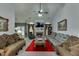 Comfortable living room featuring a fireplace, ceiling fan, and stylish furnishings at 1258 Rocky Branch Trl, Lawrenceville, GA 30043