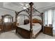 This spacious main bedroom features an ornate four-poster bed and neutral decor at 1258 Rocky Branch Trl, Lawrenceville, GA 30043