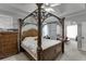 This neutral and bright main bedroom features an ornate bedframe and neutral-toned decor at 1258 Rocky Branch Trl, Lawrenceville, GA 30043