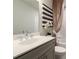 Modern bathroom featuring a gray vanity, decorative mirror, and stylish shower curtain at 4277 Azalea Ridge Way, Hoschton, GA 30548