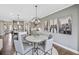 Cozy breakfast nook adjacent to the kitchen with modern lighting and comfortable seating at 4277 Azalea Ridge Way, Hoschton, GA 30548