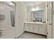 Bright bathroom featuring double sinks, shower-tub combo, white cabinets and trim, and tile floors at 1384 Sheffield Glen Ne Way, Atlanta, GA 30329