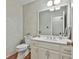 Cozy half bathroom featuring a mirror, a toilet, and a wood floor at 1384 Sheffield Glen Ne Way, Atlanta, GA 30329