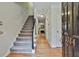 Light and airy foyer with hardwood floors, stairs, and view to a fireplace at the end of the hall at 1384 Sheffield Glen Ne Way, Atlanta, GA 30329