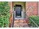 Close-up of the home's brick front entrance and black door with the address 1384 at 1384 Sheffield Glen Ne Way, Atlanta, GA 30329