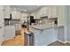 Bright kitchen with modern appliances, light cabinets, granite countertops and hardwood floors at 1384 Sheffield Glen Ne Way, Atlanta, GA 30329