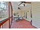 Enjoy the views from this screened porch with a table and chairs, ceiling fans, and easy access to the yard at 1384 Sheffield Glen Ne Way, Atlanta, GA 30329