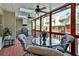 Relaxing screened porch with ceiling fans, skylights, dining table, and a grill for easy outdoor entertaining at 1384 Sheffield Glen Ne Way, Atlanta, GA 30329