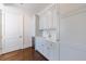 Wet bar with modern white cabinets, marble countertops and a wine cooler at 3364 Knollwood Nw Dr, Atlanta, GA 30305