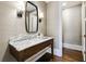 Elegant bathroom with a marble countertop, modern lighting fixtures, and a stylish mirror at 3364 Knollwood Nw Dr, Atlanta, GA 30305