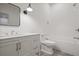 Bright bathroom features a white vanity, a tile surround bathtub, modern lighting and chrome fixtures at 3364 Knollwood Nw Dr, Atlanta, GA 30305