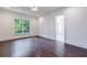 Well-lit bedroom with hardwood floors, a large window, and an en-suite bathroom at 3364 Knollwood Nw Dr, Atlanta, GA 30305