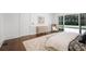 Bright bedroom features wood floors, stylish furnishings, and a seamless transition to outdoor pool area through glass doors at 3364 Knollwood Nw Dr, Atlanta, GA 30305