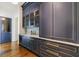 Detailed shot of a butler's pantry featuring navy cabinets, gold hardware, and marble countertops at 3364 Knollwood Nw Dr, Atlanta, GA 30305