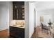 Butler's pantry with dark cabinetry, a gold faucet, and a connecting hallway at 3364 Knollwood Nw Dr, Atlanta, GA 30305