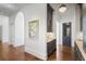 Hallway featuring a butler's pantry with dark cabinets, brass hardware, and marble countertops at 3364 Knollwood Nw Dr, Atlanta, GA 30305