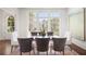 Spacious dining room with a clear table, stylish chairs, large windows and hardwood floors at 3364 Knollwood Nw Dr, Atlanta, GA 30305
