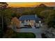 Stunning traditional style home at sunset with manicured landscaping and an extended driveway at 3364 Knollwood Nw Dr, Atlanta, GA 30305