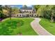 Beautiful home with a lush green lawn, long driveway, and meticulously maintained landscaping at 3364 Knollwood Nw Dr, Atlanta, GA 30305